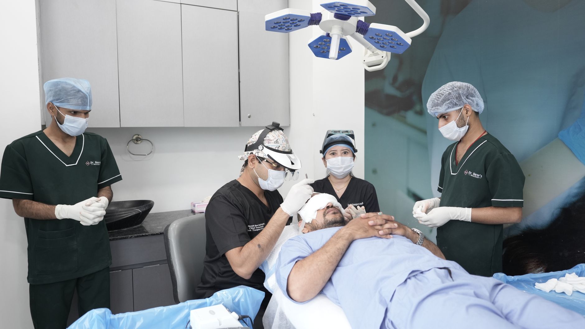 Medical professionals conducting a hair transplant in a clinic setting