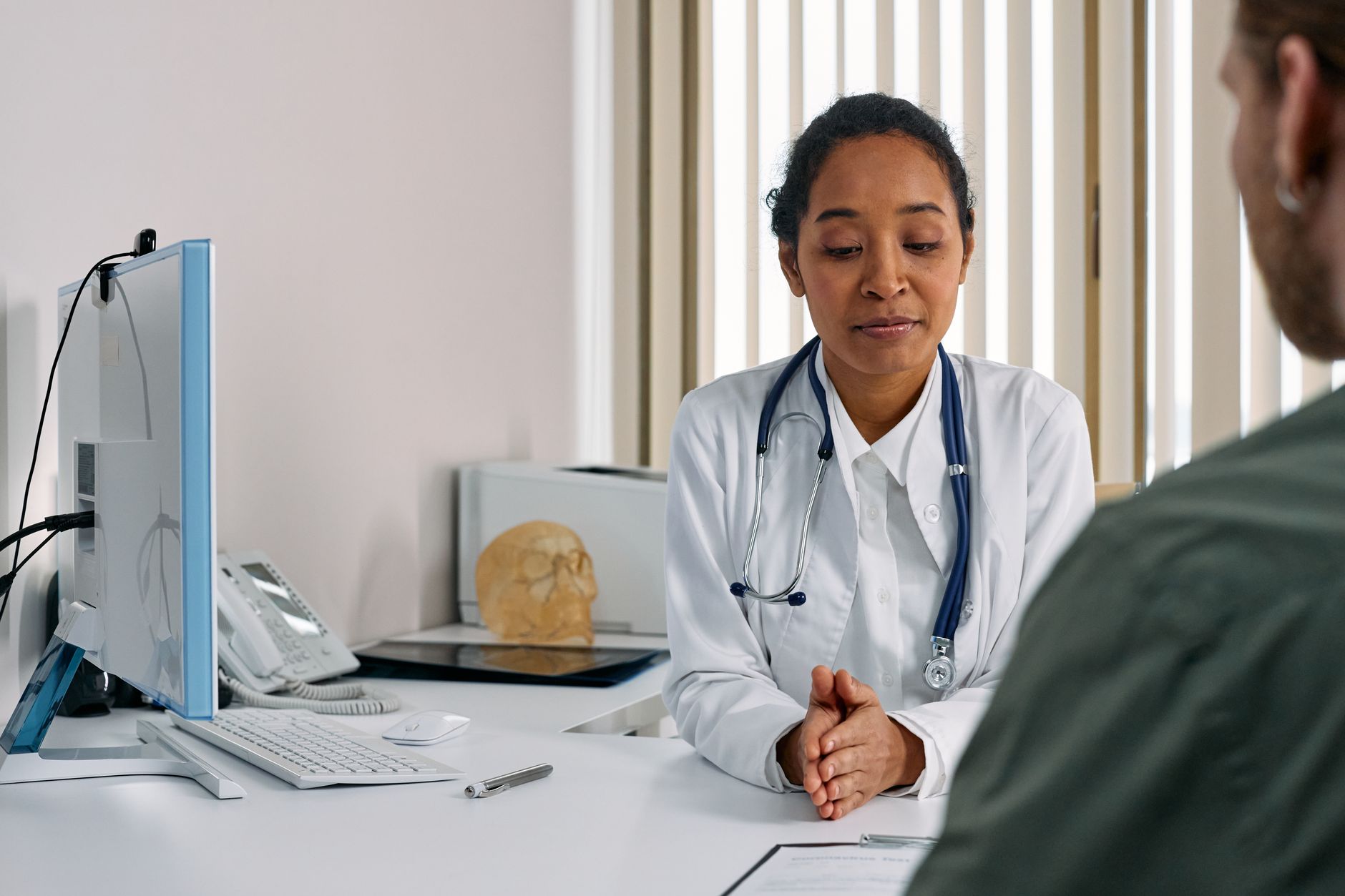 Healthcare professional reviews a medical form during a patient consultation